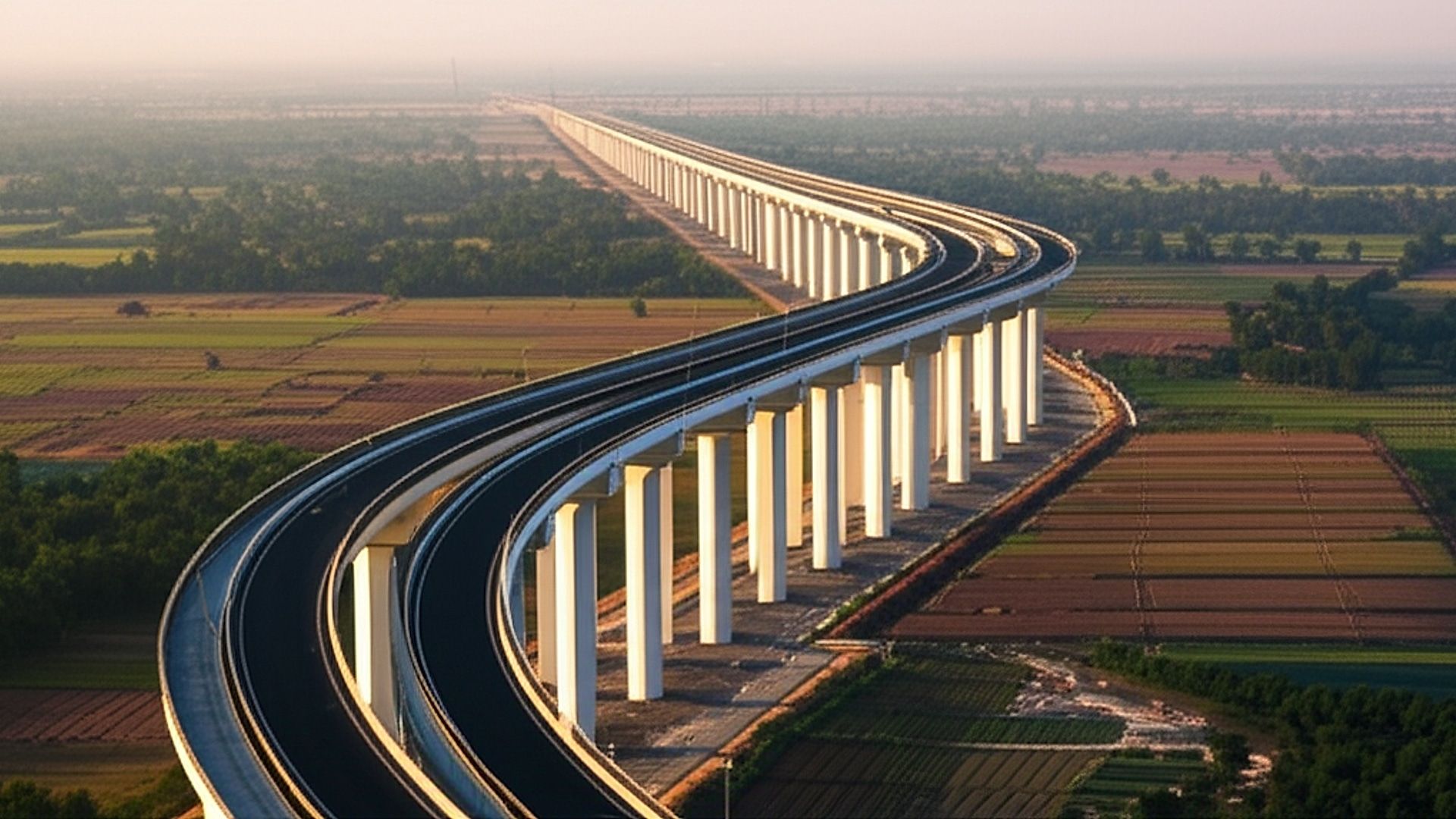 High-resolution architectural photograph of the NH-19 Six-Lane Elevated Flyover in East India. Capture a sweeping view emphasizing the flyover's modern design and scale, including its supporting pillars and approaches. Golden hour lighting; soft, warm light illuminating the structure with long shadows, showcasing the surrounding landscape. Professional architectural photography style: sharp focus, wide-angle lens, clear skies, minimal distractions, and subtle post-processing for enhanced clarity and color accuracy. Aim for a portfolio-worthy image highlighting engineering excellence.. Professional architectural photography, ultra-high quality, sharp focus, vivid colors, dramatic lighting, golden hour, cinematic composition, 8K UHD, photorealistic.