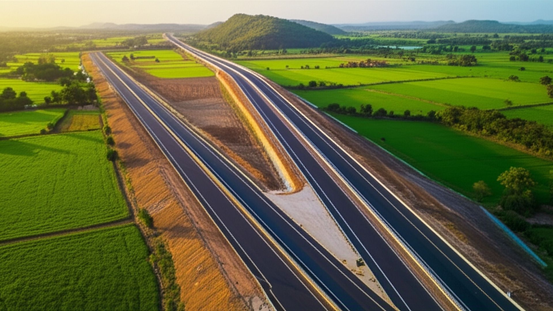 Architectural photograph showcasing the newly constructed NH-544G six-lane access-controlled greenfield highway in Andhra Pradesh. Capture a sweeping perspective emphasizing the highway's modern design and smooth asphalt surface. Setting is a rural Andhra Pradesh landscape with rolling hills in the background and lush green fields flanking the highway. Golden hour lighting, soft directional sunlight casting long shadows emphasizing the texture and scale of the road. Professional architectural photography, sharp focus, wide-angle lens, vibrant natural colors, minimal post-processing.. Professional architectural photography, ultra-high quality, sharp focus, vivid colors, dramatic lighting, golden hour, cinematic composition, 8K UHD, photorealistic.